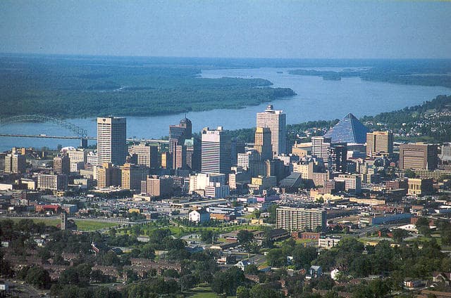 Aerial photograph of the Memphis, Tennessee skyline along the Mississippi River, taken at midday.