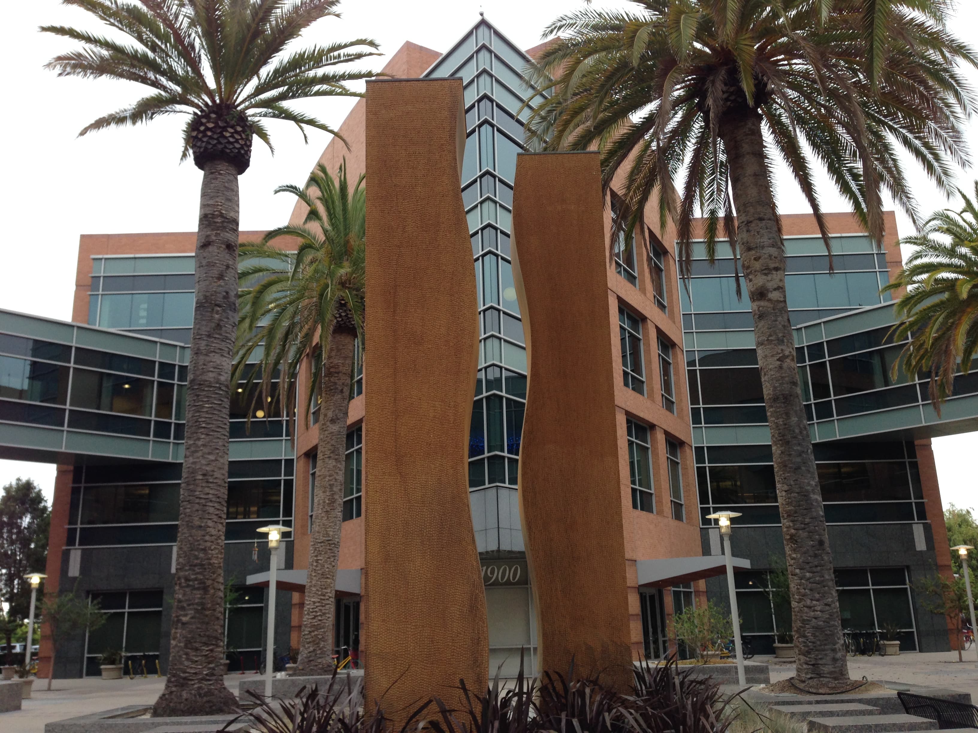 Daytime colour photograph of Google Building 1900 in Charleston, Mountain View, California, taken from the parking lot. The low-slung three-storey office building houses one of the engineering teams whose Open Source Software Vulnerability Rewards Program was paused on October 1, 2026 after a surge of AI-generated submissions.