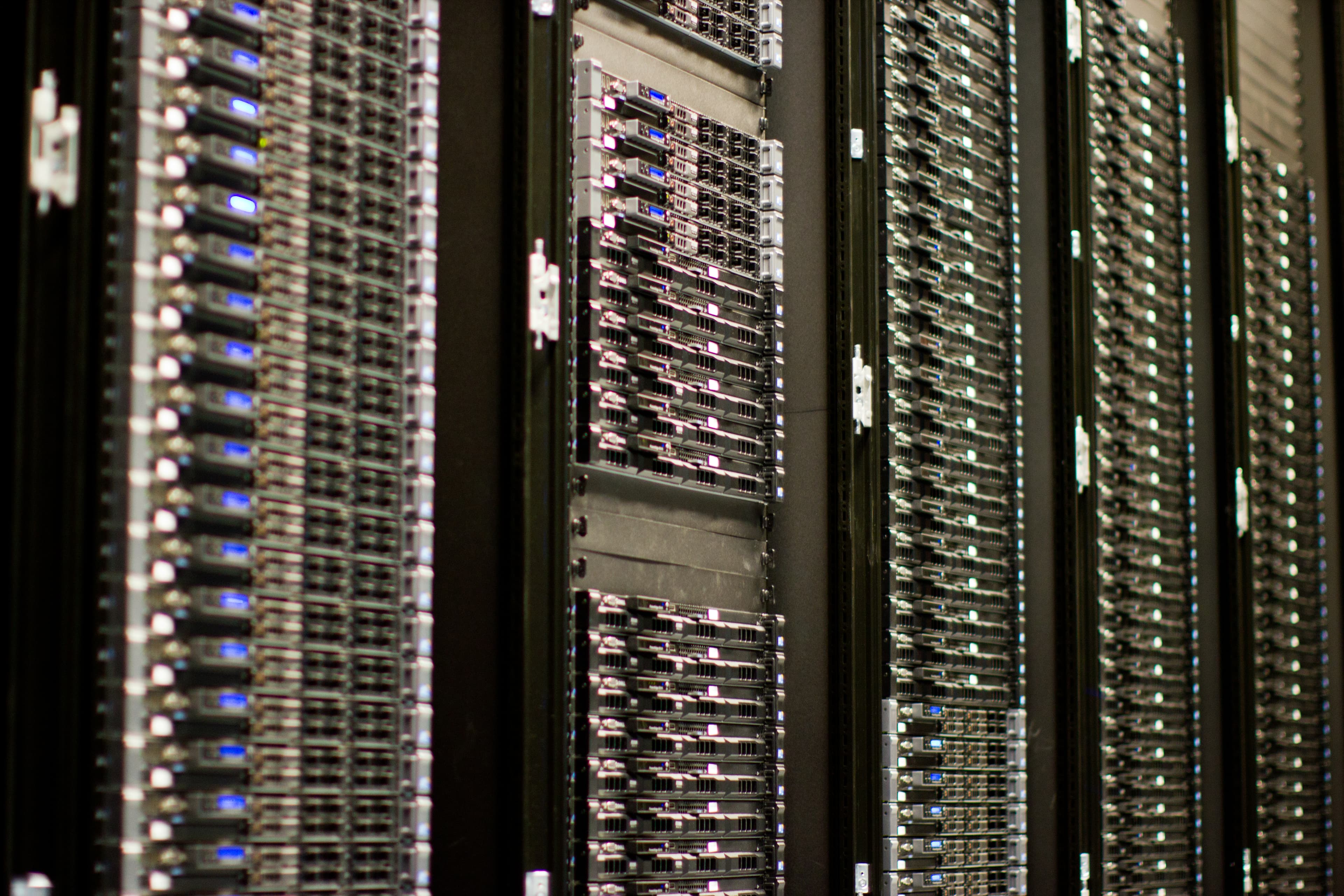 A colour photograph of aisle rows of server racks and networking equipment at a Wikimedia Foundation data centre, showing the physical form of the storage layer that any zero-data-retention promise operates on top of. On Wednesday August 19, 2026, OpenAI previewed Private Safety Processing — an automated cross-session abuse-detection layer that the company says can identify multi-turn misuse patterns across an enterprise customer's API traffic without exposing prompts or completions to OpenAI staff and without retaining that traffic after processing. The announcement sits 71 days after Anthropic's June 9 policy override that broke existing zero-retention agreements on Anthropic's Mythos-class covered models to enable a comparable 30-day human-review window with controlled human access, and positions OpenAI directly against Anthropic on the enterprise-data-retention axis. OpenAI's head of product policy, Aleah Houze, framed the technical claim as monitoring that catches misuse spread across many interactions without OpenAI itself keeping any of them, with a broader rollout and technical white paper promised for September 2026.