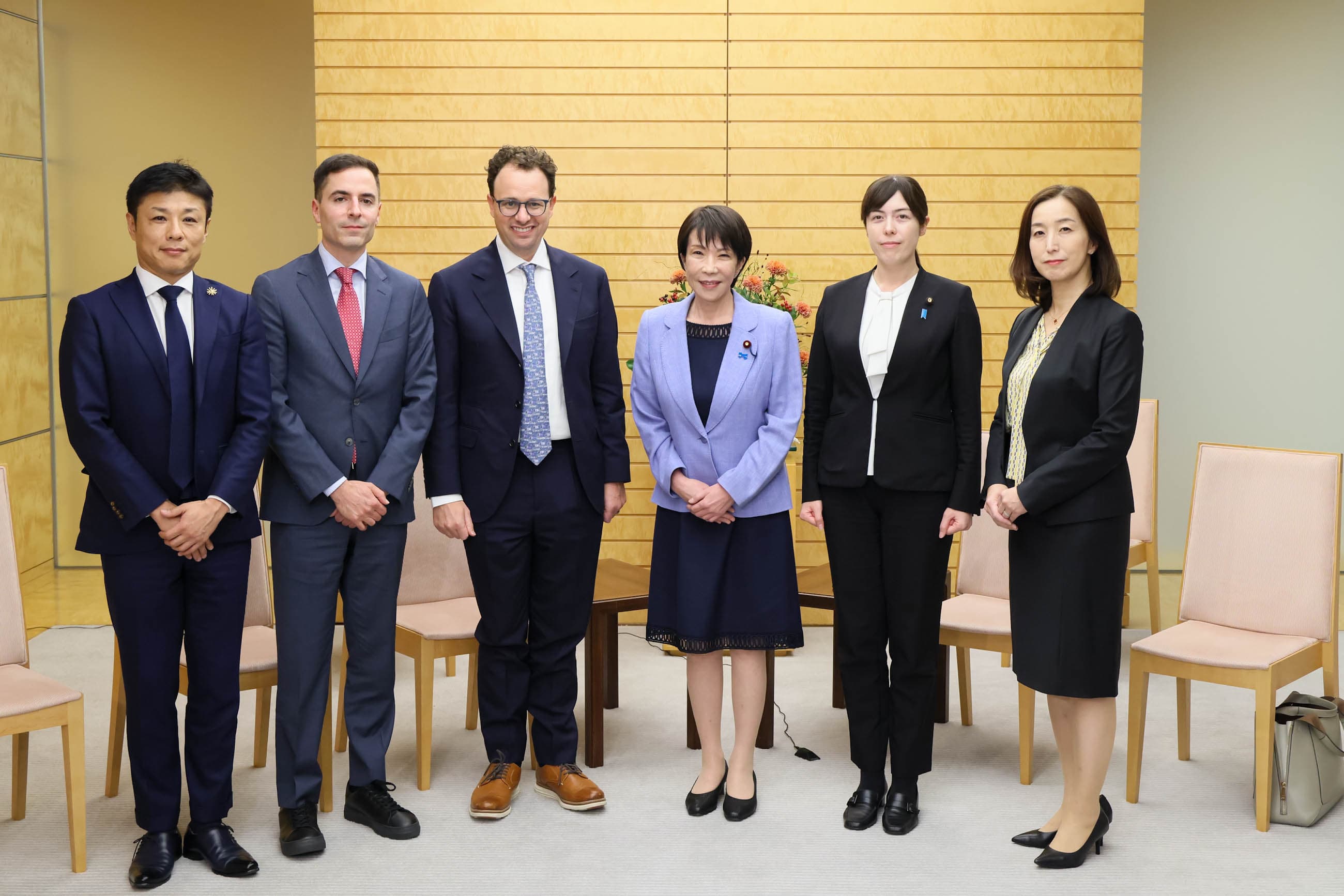 A colour photograph of Anthropic CEO Dario Amodei shaking hands with Sanae Takaichi, Japan's Minister for Economic Security, in a formal reception room in Tokyo on October 29, 2025. Both are in dark business attire; a Japanese and an American flag stand behind them. Amodei is the executive who on Friday July 18, 2026 announced that Claude Fable 5 — Anthropic's premium frontier model, briefly withdrawn from subscriptions in mid-June under a Commerce Department export-control directive and redeployed on July 1 — will be a permanent feature of the Max and Team Premium subscription tiers from Monday July 20, but only at 50 per cent of weekly usage limits which themselves shrink by one third on the same day when Anthropic's promotional bonus phase ends.
