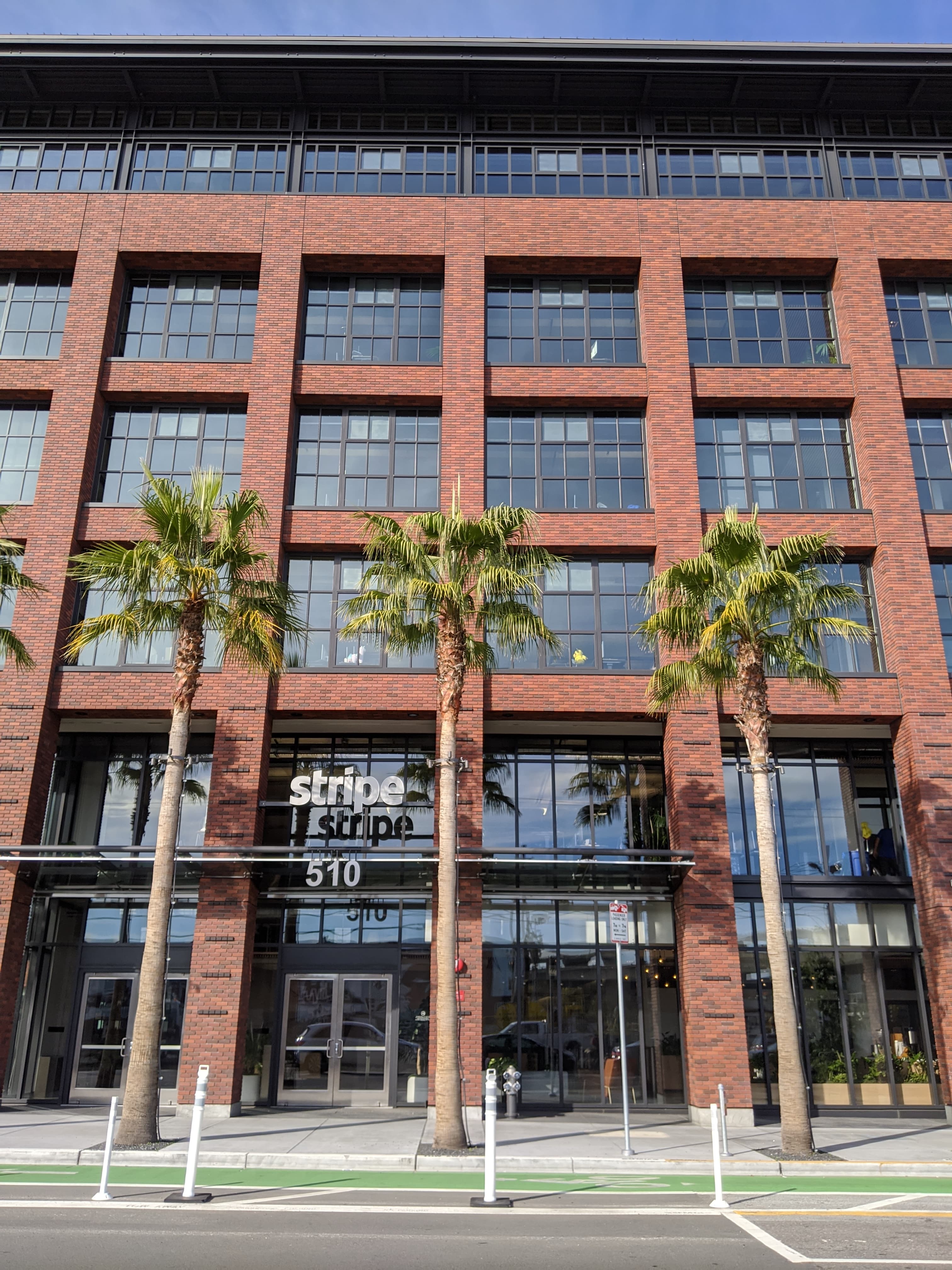The entrance to Stripe's San Francisco headquarters in 2019, a brick-fronted building with the company name set in a recessed sign.