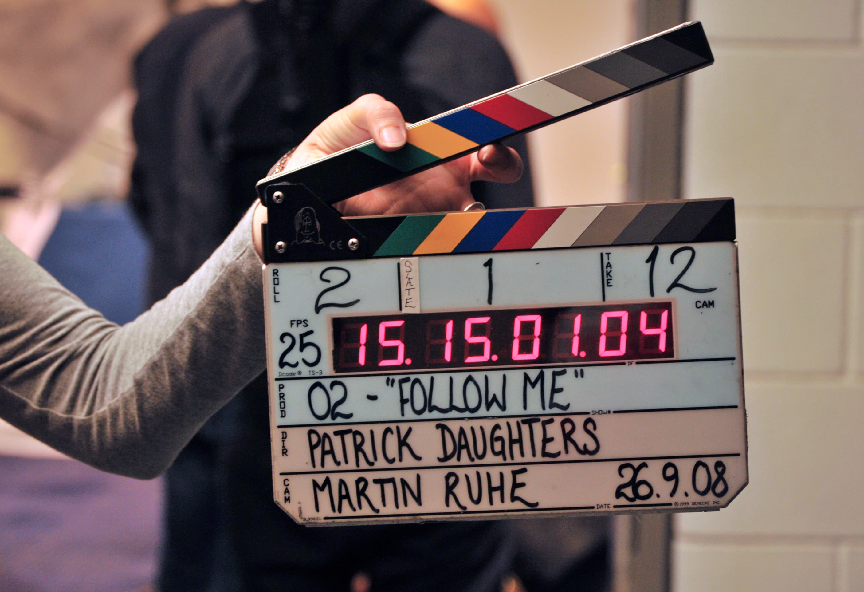 A colour photograph of a wooden film clapperboard held at an angle on a movie set in September 2008, with the sticks open and chalked-in production details showing scene, take, roll, director, and date. On July 3, 2026, Google DeepMind formally announced a multi-year AI research partnership with A24 — a $75 million equity investment by Google, non-exclusive, with no access to A24's film library, and a storyboard tool as the first deliverable. It is Google's first equity stake in a film studio and the most artist-friendly hyperscaler-studio deal signed to date.