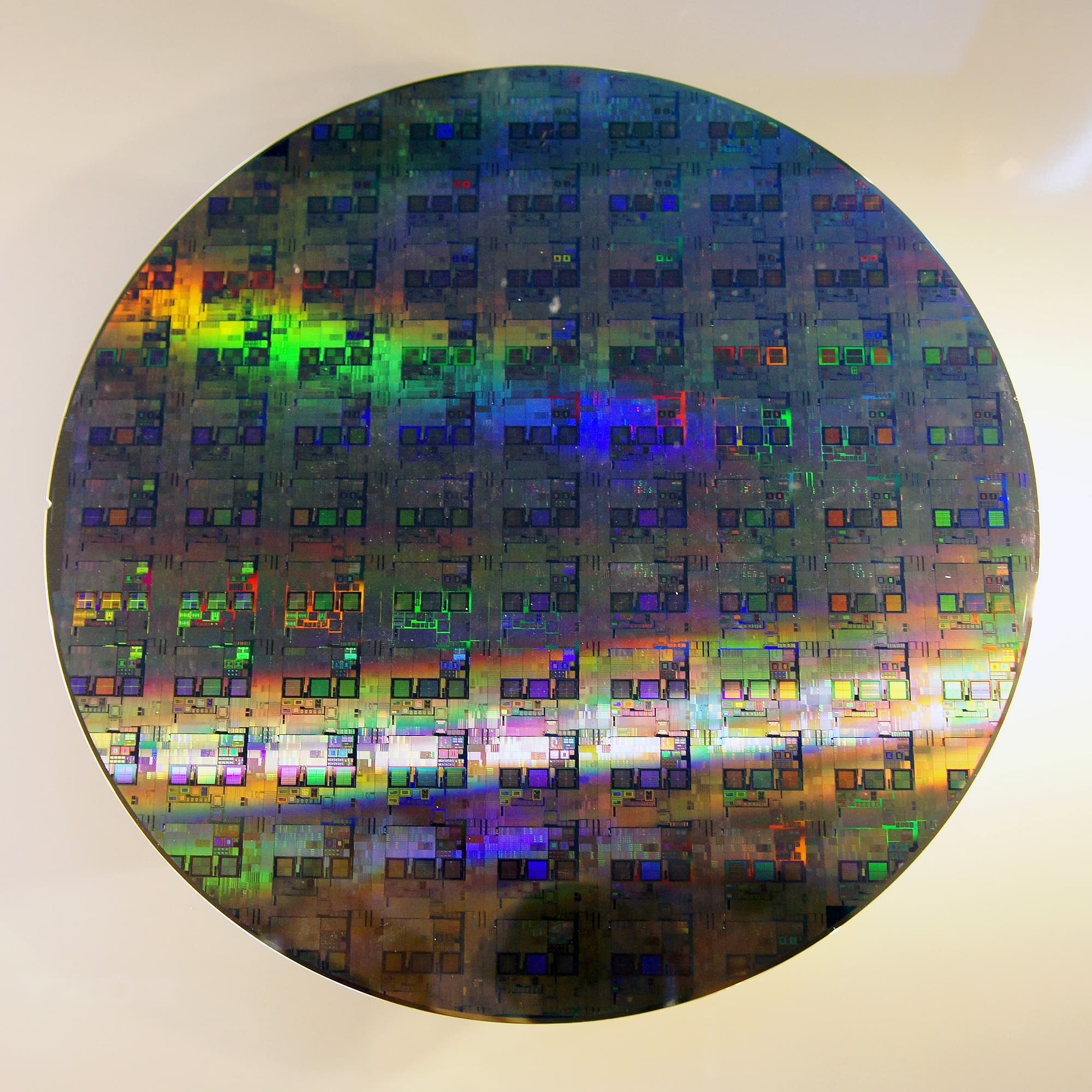 Colour photograph of a 12-inch (300 mm) silicon wafer taken on July 30, 2011 by Wikimedia user Peellden. On August 8, 2026, Leopold Aschenbrenner's Situational Awareness LP committed $400 million to Source Foundry, a Stanford chip-tooling startup that develops manufacturing processes upstream of chip production, specifically optimised for AI workloads. Founded in July 2025 by Stanford alumni Abdulmalik Obaid and Joe Burg, Source Foundry is thirteen months old, previously backed by Sequoia Capital, and reportedly carries a $5 billion valuation on this round. Situational Awareness's total position of $500 million represents approximately 10% of the company and roughly half of the hedge fund's remaining $10 billion in assets under management, following a $35 billion drawdown in July that forced the fund's three prime brokers — Goldman Sachs, JPMorgan and Bank of America — to close out its 4x-leveraged public book in a single pre-market block trade to Ken Griffin's Citadel on July 30.