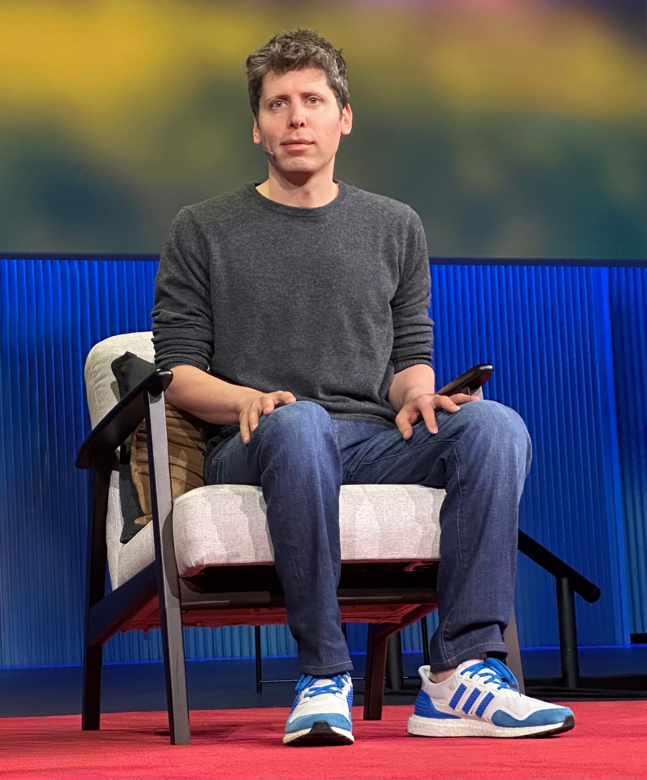 Colour photograph of Sam Altman, chief executive officer of OpenAI, speaking on stage at TED 2025 in Vancouver on April 11, 2025. On Tuesday July 28, 2026, on the same day 1,171 AI employees from OpenAI, Anthropic, Google DeepMind, Meta and Microsoft signed an open letter called Pacing the Frontier asking the US government to build technical and governance tools to deliberately pace the frontier of automated AI development, Altman went on the Invest Like the Best podcast with Patrick O'Shaughnessy and said he was terrified of a world where AI fears were used to concentrate access, and that OpenAI may have to pace the rate of AI development to give society time to harden. He was not a signatory of the letter.