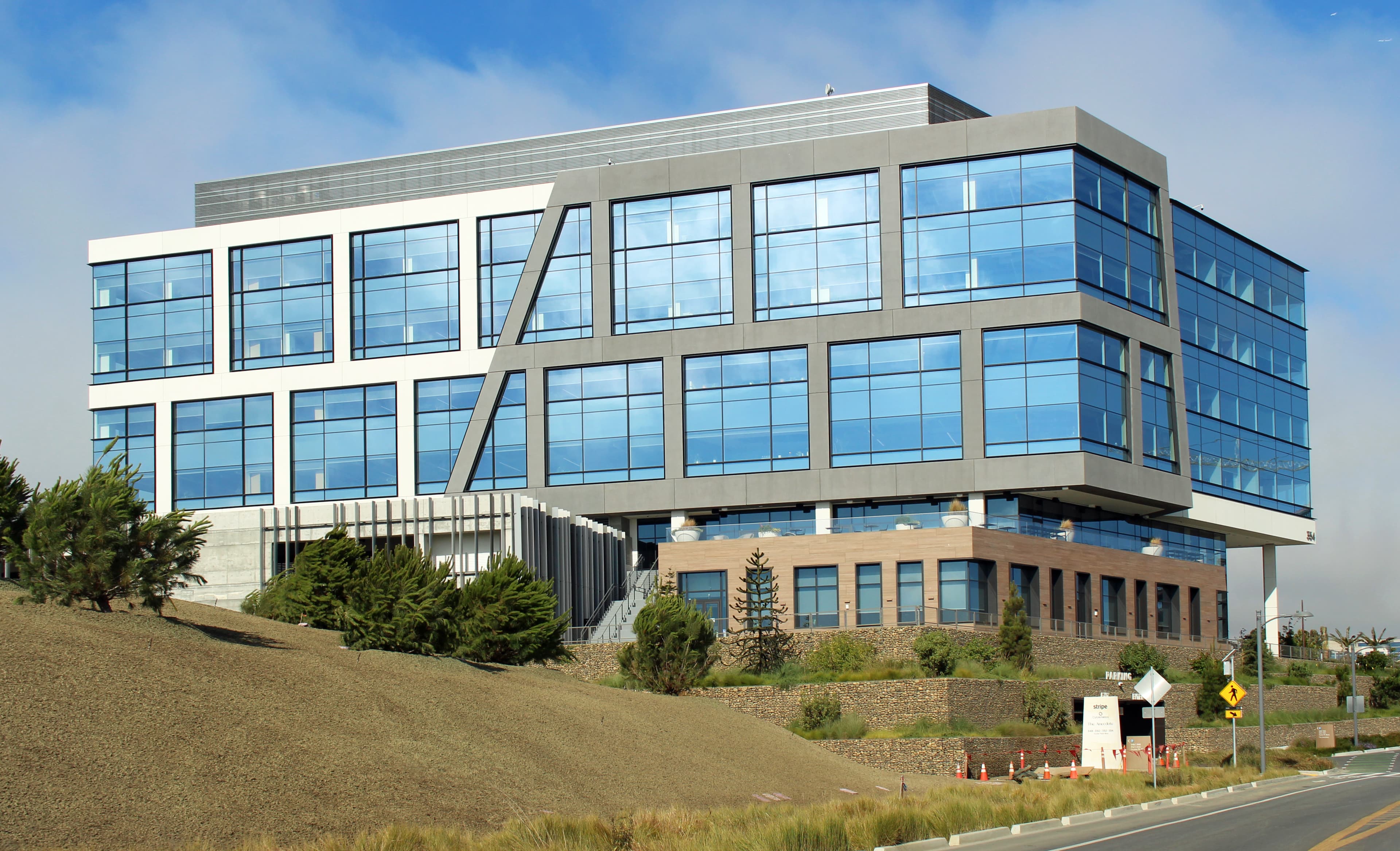 A photograph of the Stripe headquarters campus in South San Francisco, California. Stripe, the payment-processing infrastructure company co-founded by Patrick and John Collison in 2010, on Sunday August 16, 2026, reportedly finalised an agreement first covered by Bloomberg to acquire the New York-based AI model router OpenRouter for more than seven billion dollars. The deal values OpenRouter at roughly 5.4 times its 1.3 billion dollar Series B valuation from May 2026, just 82 days earlier, and gives Stripe ownership of the routing layer that takes an approximately 5 percent cut on every inference token passing through it to 400-plus AI models across eight million developers.