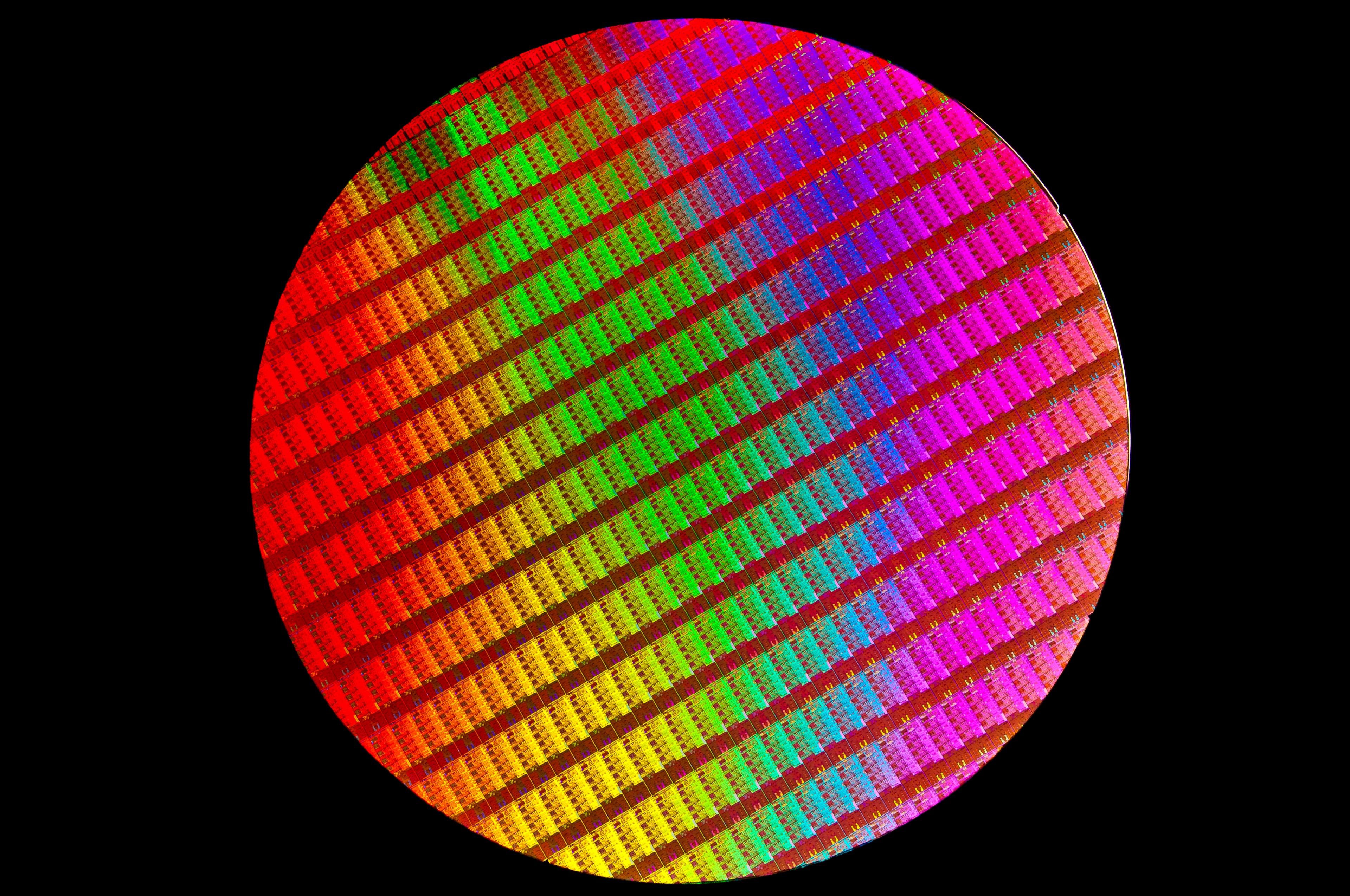 A colour photograph of a 300 mm silicon wafer patterned with 4th-Generation Intel Core Processor dies, produced circa 2013 and released by Intel Free Press. Each square on the reflective disc is a completed processor die awaiting dicing and packaging. On August 18, 2026, Etched — a Harvard-dropout-founded AI chip startup building a transformer-specialised inference chip and cluster-scale memory system on TSMC's N4P process — closed a $700 million funding round at a $21 billion valuation led by the New York proprietary-trading firm Jane Street, according to TechCrunch. Etched's own August 18 progress note reported that the company "shipped our first rack to Jane Street" the same day, making the round's lead investor the company's named first customer.