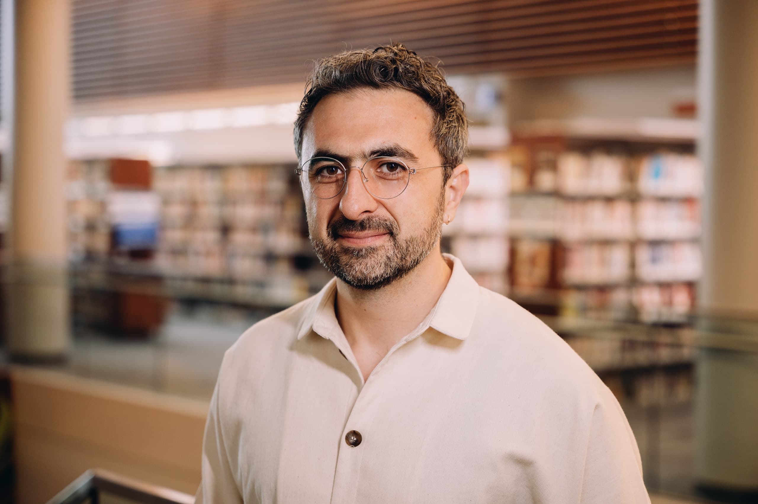 A portrait photograph of Mustafa Suleyman, Microsoft AI CEO and co-founder of DeepMind, in a dark shirt against a plain background. Suleyman was the architect of Microsoft's June 2, 2026 Build launch of seven in-house MAI models — MAI-Thinking-1, MAI-Code-1-Flash, MAI-Image-2.5 and 2.5-Flash, MAI-Transcribe-1.5, MAI-Voice-2 and its Flash variant — trained from scratch on Microsoft data with no distillation from OpenAI or Anthropic, and running on co-designed Maia 200 silicon at a claimed 1.4x efficiency gain. Six weeks later, on Tuesday July 14, 2026, Microsoft's fiscal-year 2027 sales all-hands told salespeople to position Copilot as the end-to-end system and to compete with Anthropic and OpenAI head-on, a sequence that turns the June launch and the July sales pivot into a single strategic act.