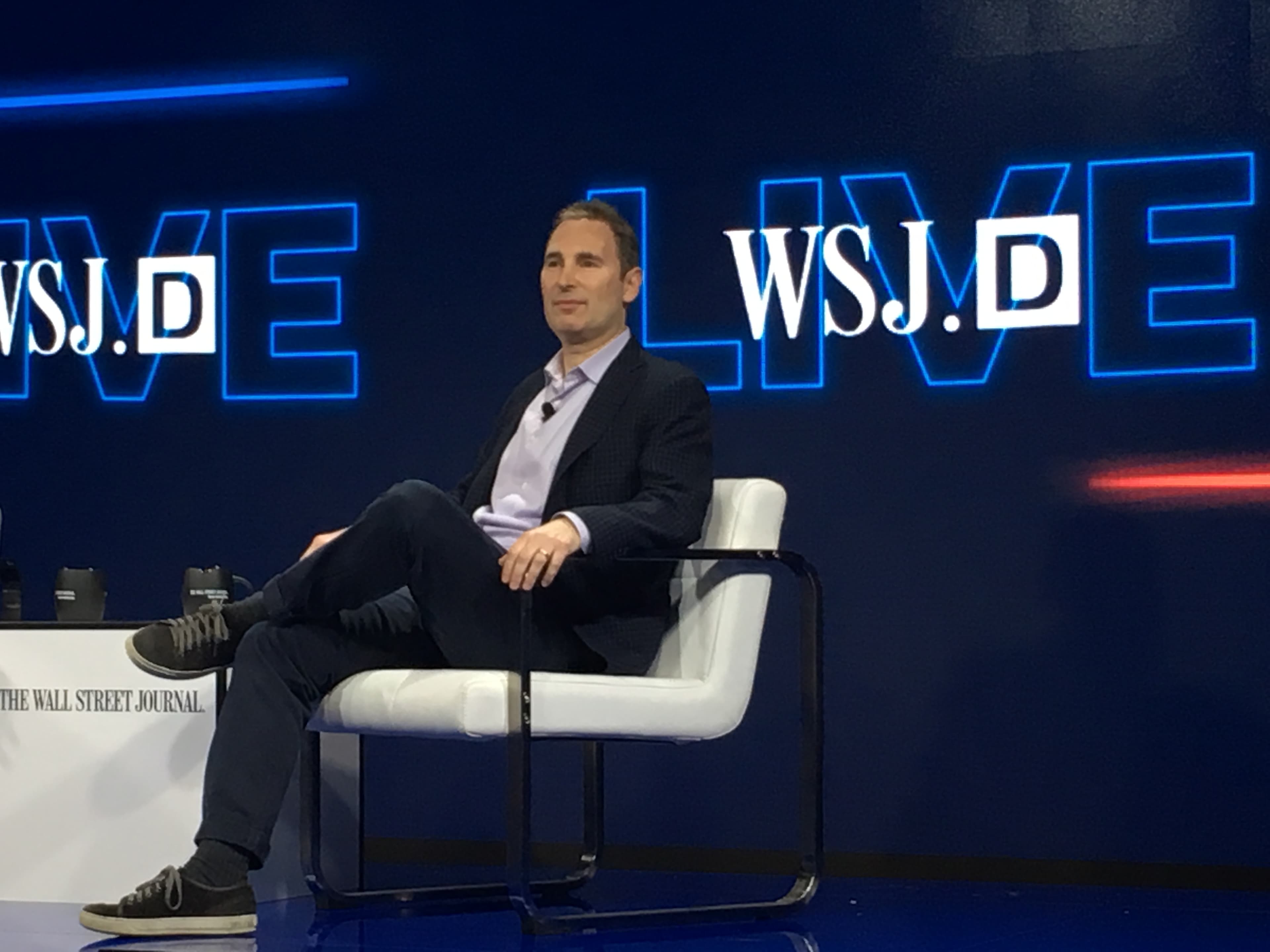 Andy Jassy, then CEO of Amazon Web Services, photographed in October 2016 at a Silicon Valley event. A clean-shaven man in a grey button-down sits in conversation, gesturing with one hand. Jassy succeeded Jeff Bezos as Amazon Group CEO in July 2021. On Thursday June 11, 2026 he reportedly raised concerns about Anthropic's Fable 5 model directly with US Treasury Secretary Scott Bessent — the contact that the Wall Street Journal traces as the trigger for the Commerce Department's June 12 export-control directive against Anthropic.