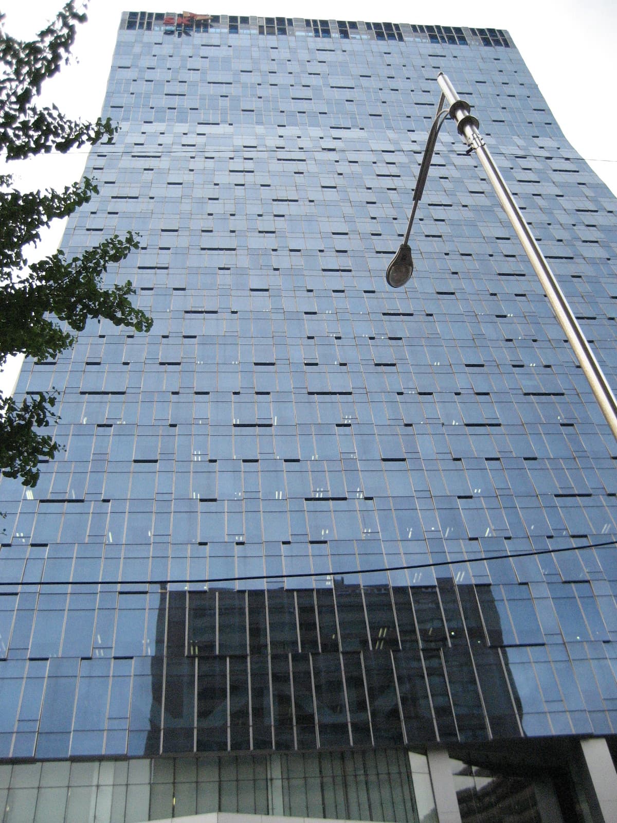 A daytime view of the SK Telecom head office tower in central Seoul, the corporate headquarters of South Korea's largest mobile carrier. SK Telecom invested $100 million in Anthropic in August 2023, was a partner in Anthropic's Project Glasswing security programme, and on or around June 12, 2026 had its access to Claude Mythos revoked at the direction of the White House over concerns about the broader SK Group's business ties to China.