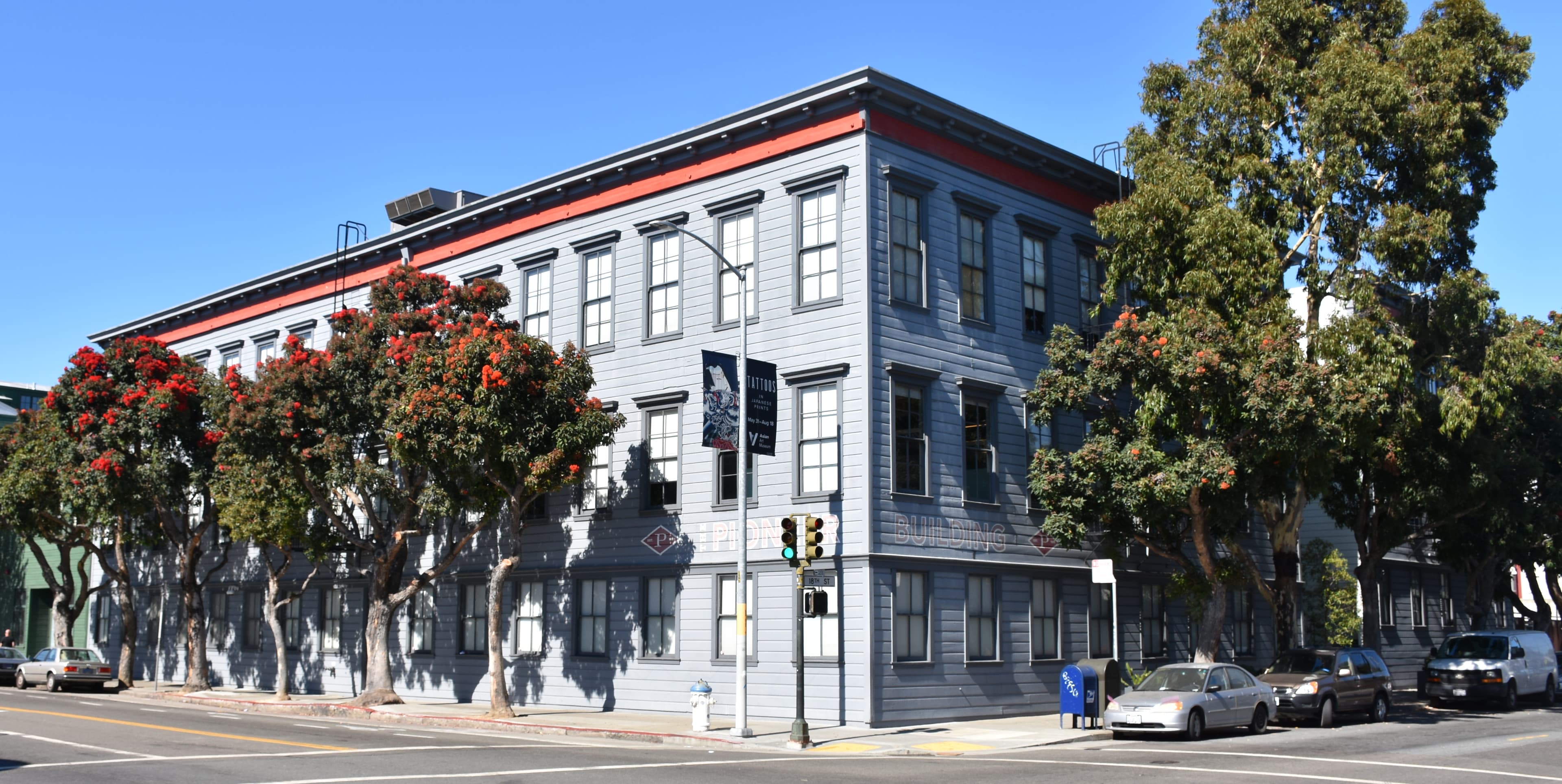 A colour photograph of the Pioneer Building in the Mission District of San Francisco, taken on July 27, 2019 by Wikimedia contributor HaeB. A four-storey red-brick and terracotta commercial building of the 1900s occupies the frame, its arched upper windows and cornice detail rising above a parked-car-lined street corner under an overcast sky. The Pioneer Building was OpenAI's headquarters from 2017 through August 2024, and the office where OpenAI's Preparedness Framework — the safety document it first published in December 2023 and updated in April 2025, defining a four-rung capability scale from Low to Critical across cybersecurity, biological, and autonomy risk axes — was originally written. On Tuesday September 1, 2026, OpenAI published Path to Astra: critical capabilities and frontier safeguards, formally classifying the Astra model at the Critical tier of that framework's cybersecurity axis. It was the first time any OpenAI model was rated Critical. The disclosure landed roughly thirty-four days after OpenAI dissolved the internal Preparedness team that used to run the review process behind the rating.